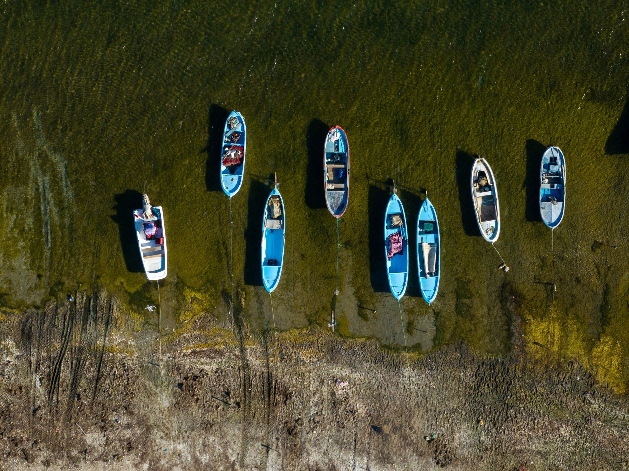 Fishing boats viewed from above on calm water