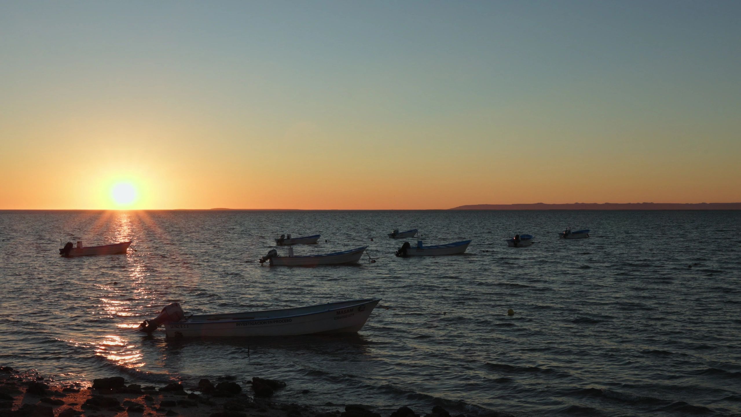 Fishing boats anchored at sunset